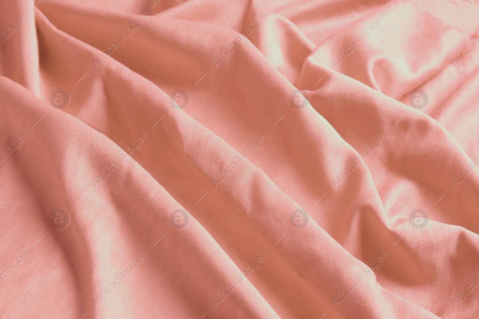 Photo of Pink shiny fabric as background, closeup view