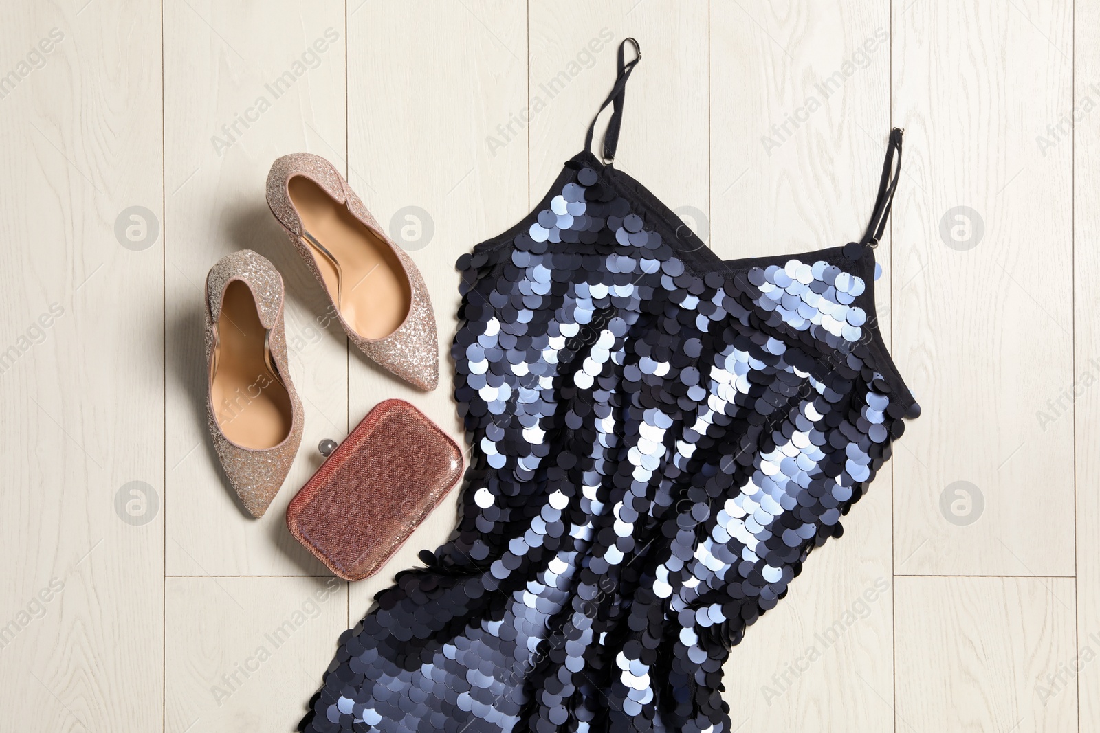 Photo of Stylish blue palette dress, bag and shoes on wooden floor, flat lay