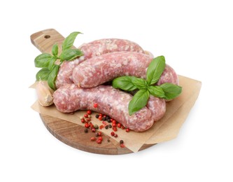 Photo of Wooden board with raw homemade sausages and different spices isolated on white