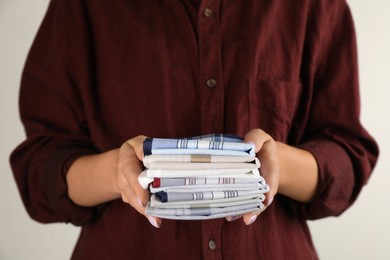 Photo of Woman holding many different handkerchiefs in hands, closeup