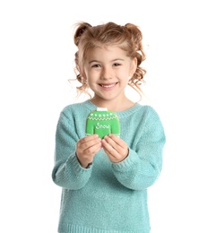 Cute little girl with Christmas gingerbread cookie on white background
