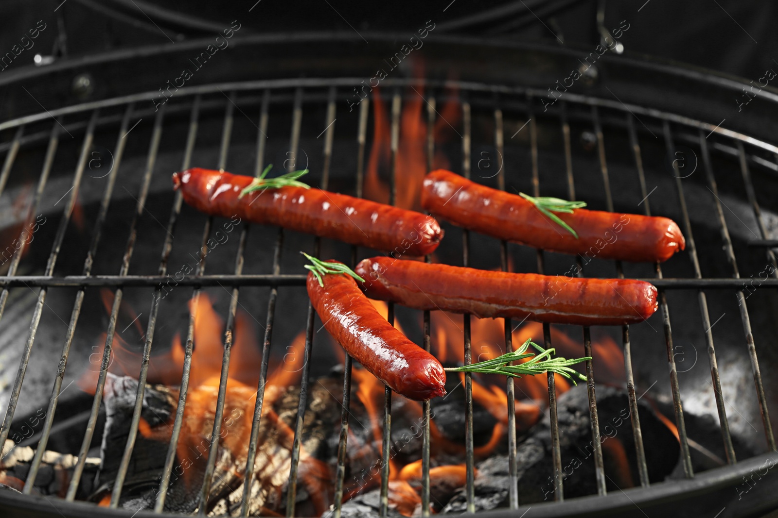 Photo of New modern barbecue grill with tasty sausages, closeup