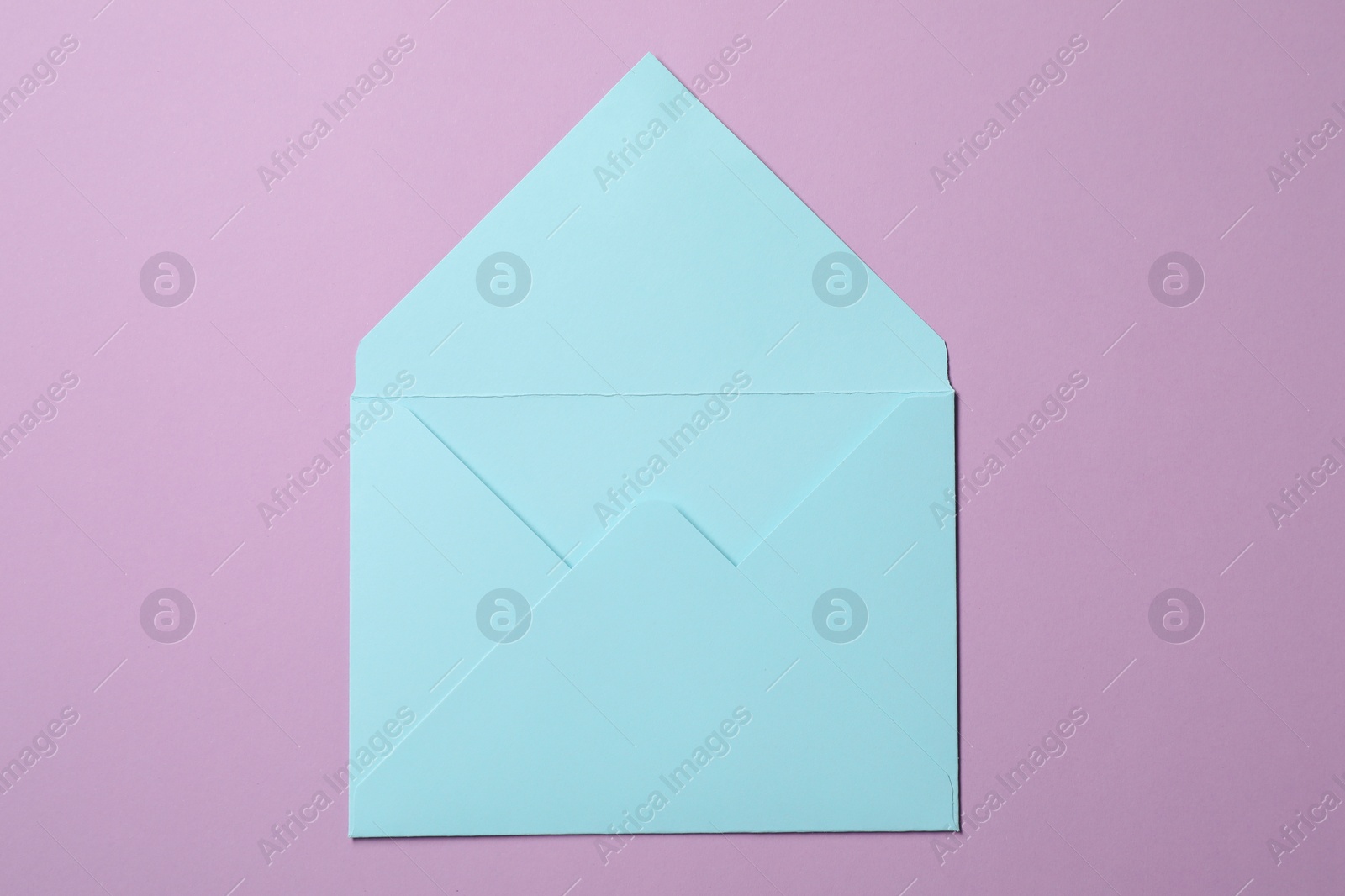 Photo of Letter envelope on violet background, top view