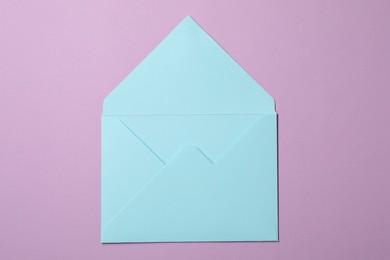 Photo of Letter envelope on violet background, top view