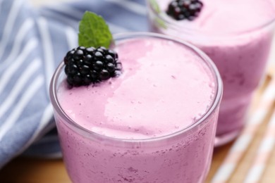 Photo of Delicious fresh blackberry smoothie in glasses, closeup