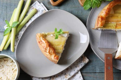 Photo of Freshly baked rhubarb pie and stalks on grey wooden table, flat lay