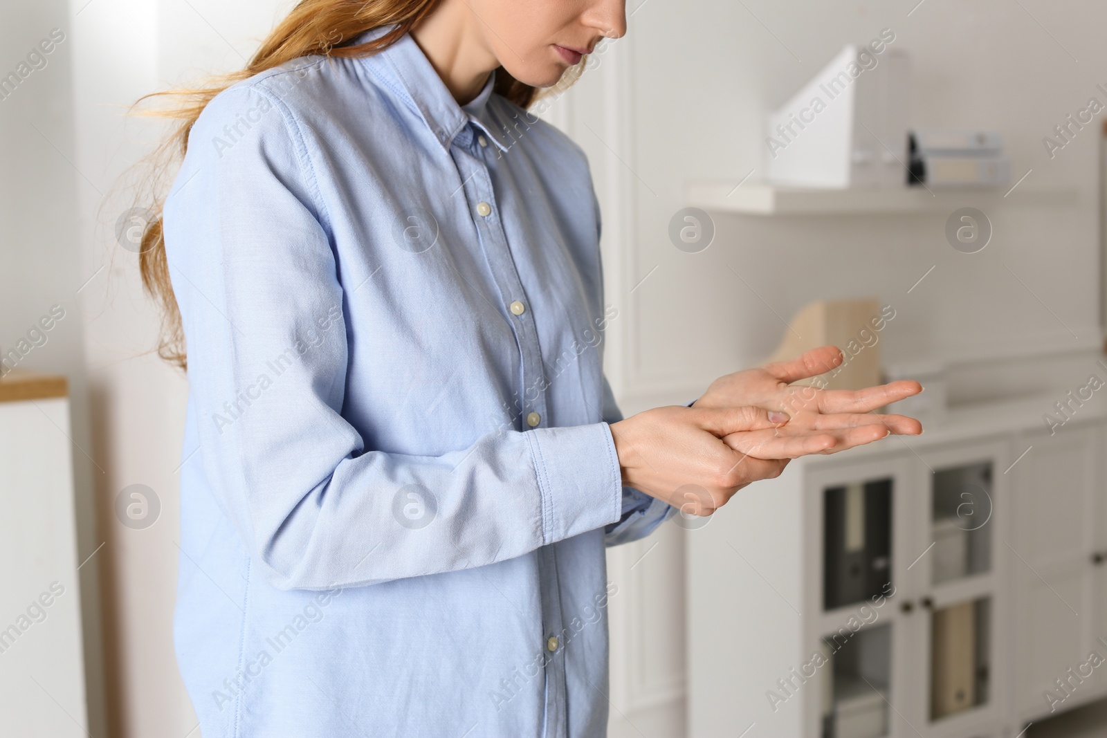 Photo of Woman suffering from trigger finger at home, closeup