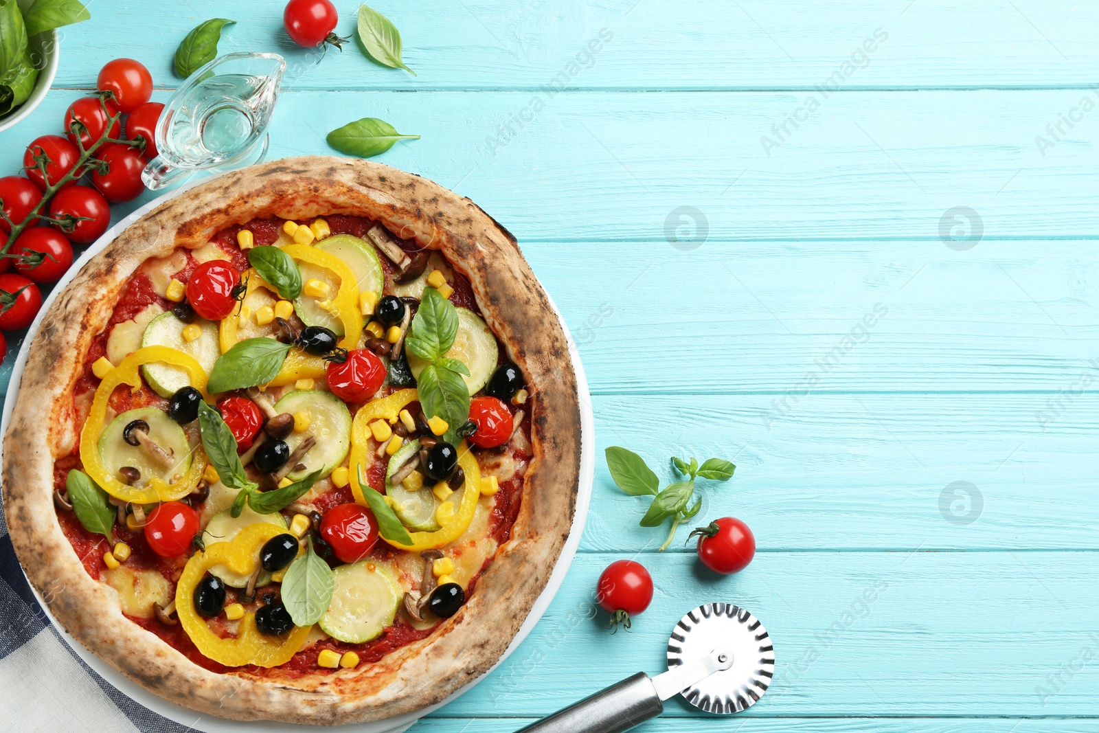 Photo of Flat lay composition with vegetable pizza on light blue wooden table. Space for text