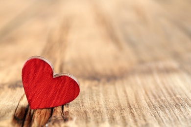 Photo of Red heart on wooden table, space for text. St. Valentine's day