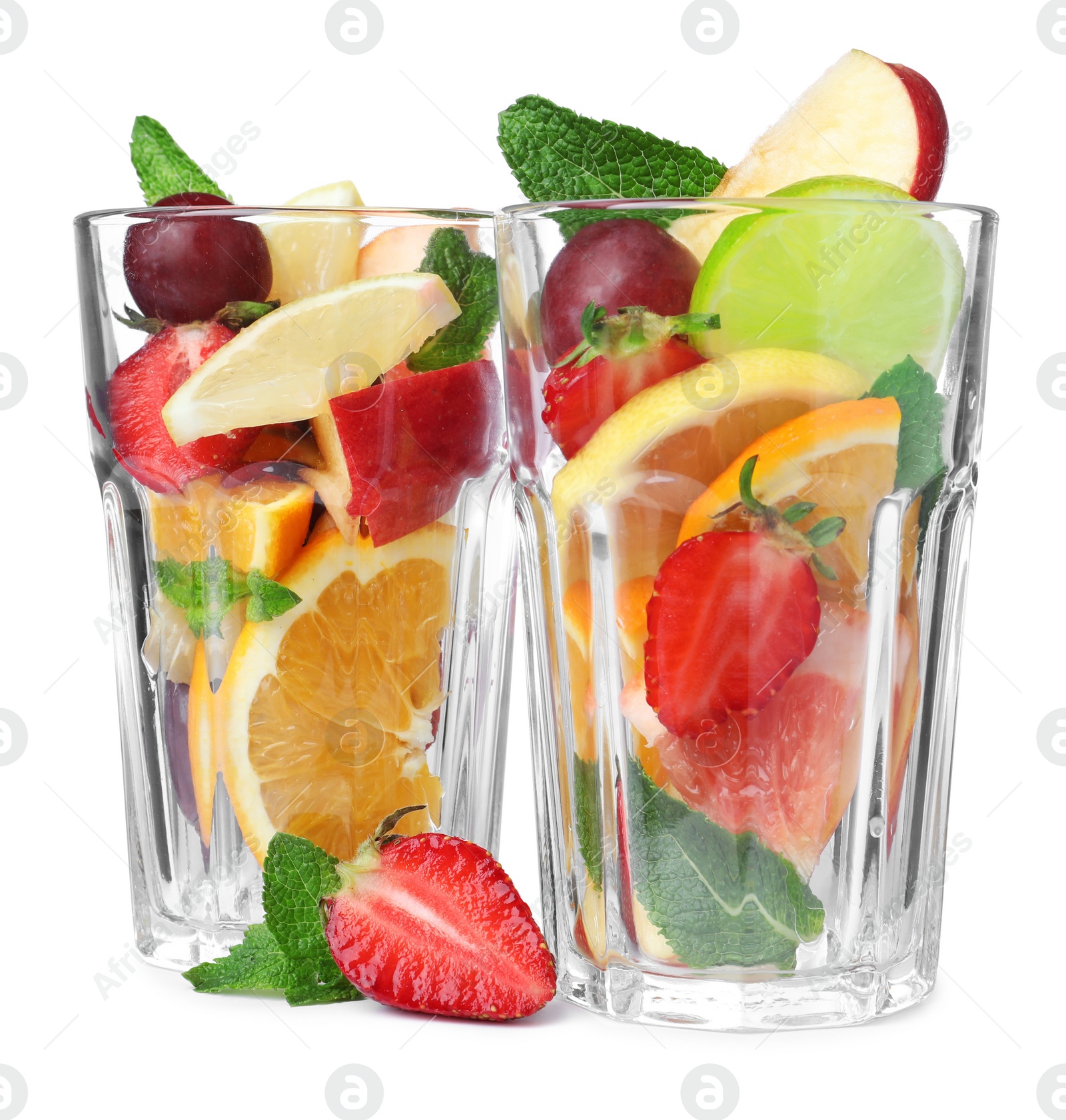 Photo of Different fruits in glasses on white background