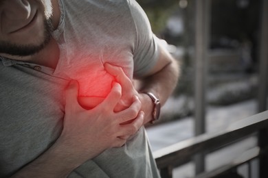 Image of Man having heart attack outdoors, closeup view