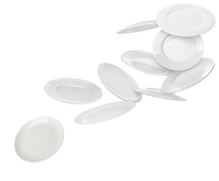 Image of Many ceramic plates falling on white background