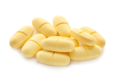 Photo of Pile of color pills on white background