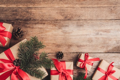 Flat lay composition with Christmas gifts on wooden table, space for text. Boxing day