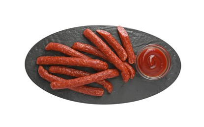 Photo of Thin dry smoked sausages served with ketchup isolated on white, top view