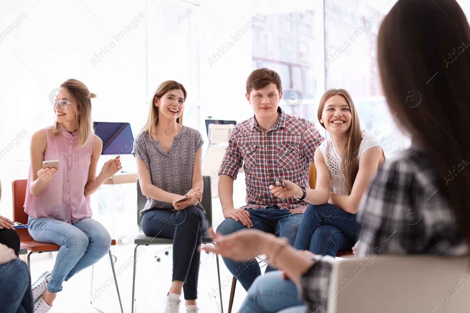 Photo of Young people having business training in office