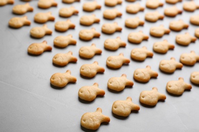 Delicious goldfish crackers on grey table, closeup