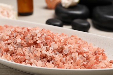 Natural sea salt in bowl on table, closeup