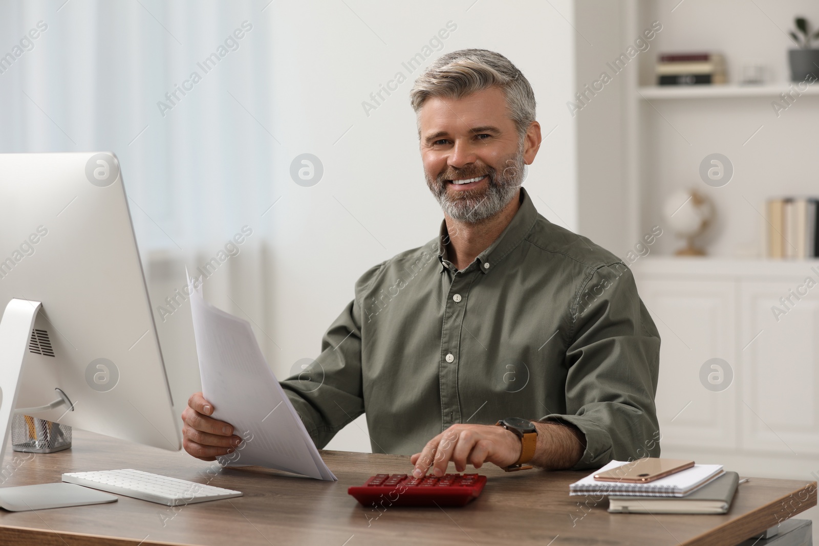 Photo of Professional accountant working at wooden desk in office