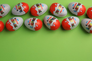 Photo of Sveti Vlas, Bulgaria - June 26, 2023: Kinder Surprise Eggs on light green background, flat lay. Space for text