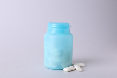 Photo of Jar with chewing gums on light grey background