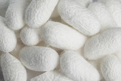 Photo of Pile of natural silkworm cocoons as background, closeup