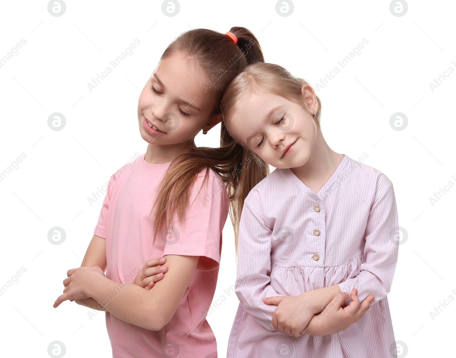 Photo of Portrait of cute little sisters on white background