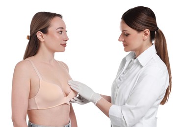 Mammologist checking woman's breast on white background