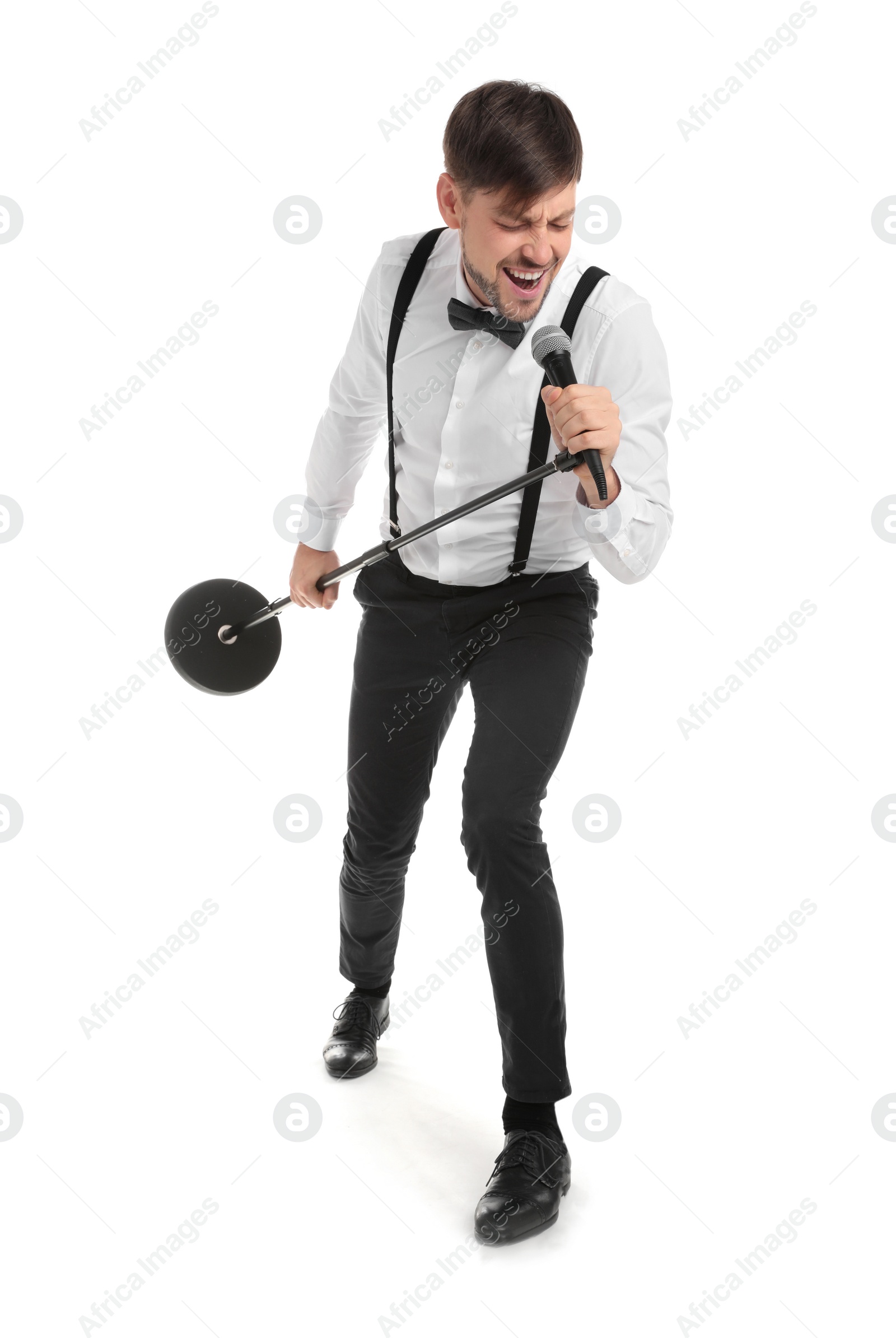 Photo of Handsome man in formal clothes singing with microphone on white background