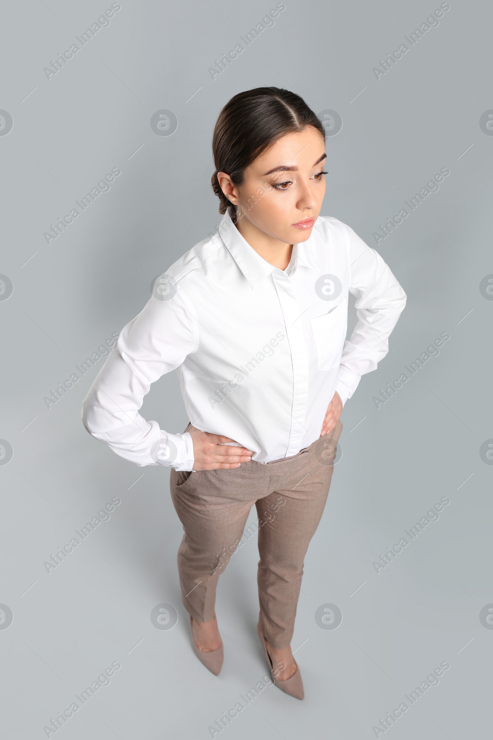 Photo of Young woman on grey background, above view