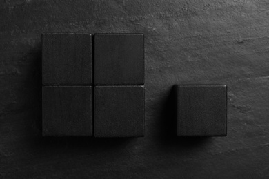 Photo of Flat lay composition with cubes on black slate background. Pareto principle concept