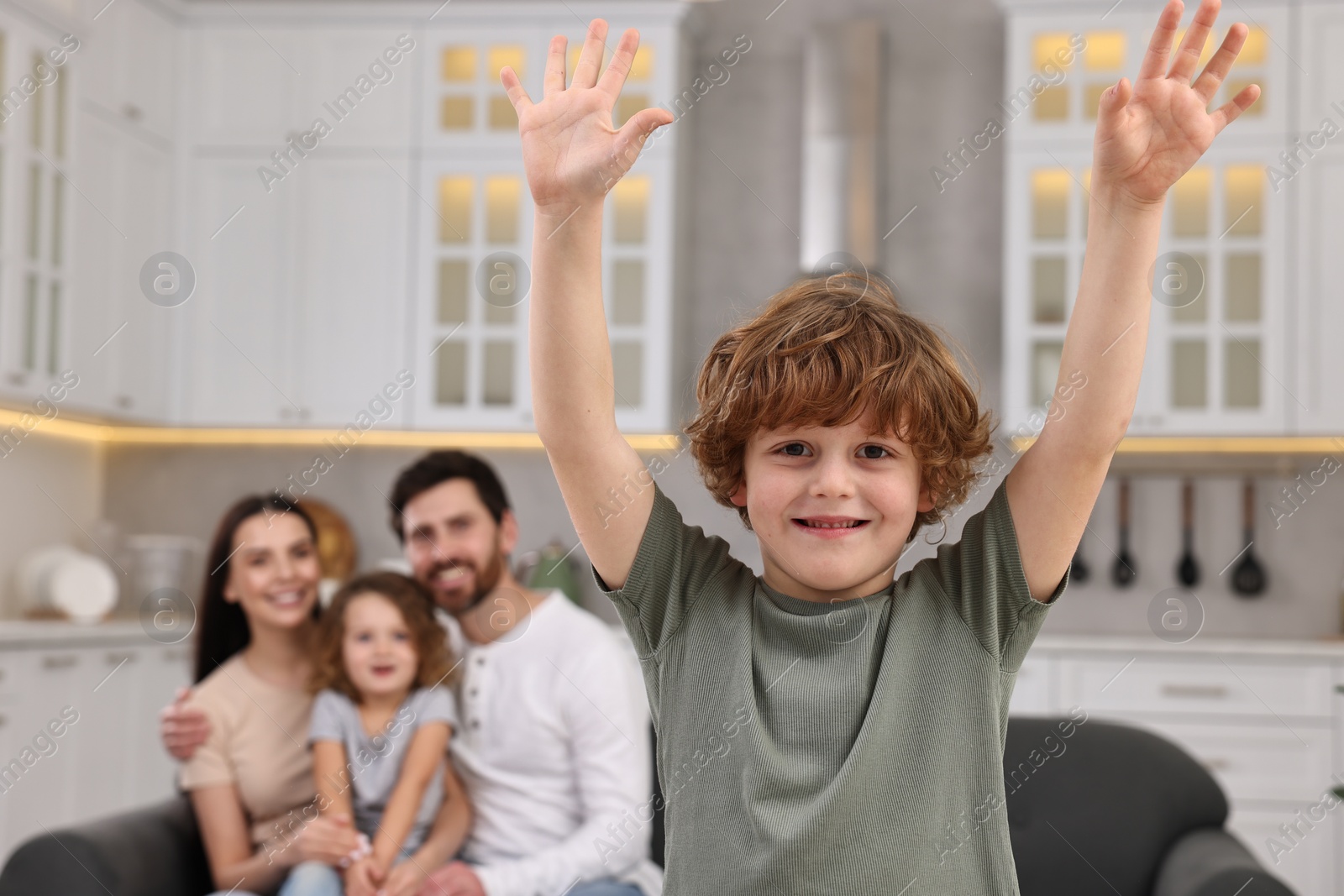 Photo of Happy family having fun at home. Son dancing while his relatives resting on sofa, selective focus