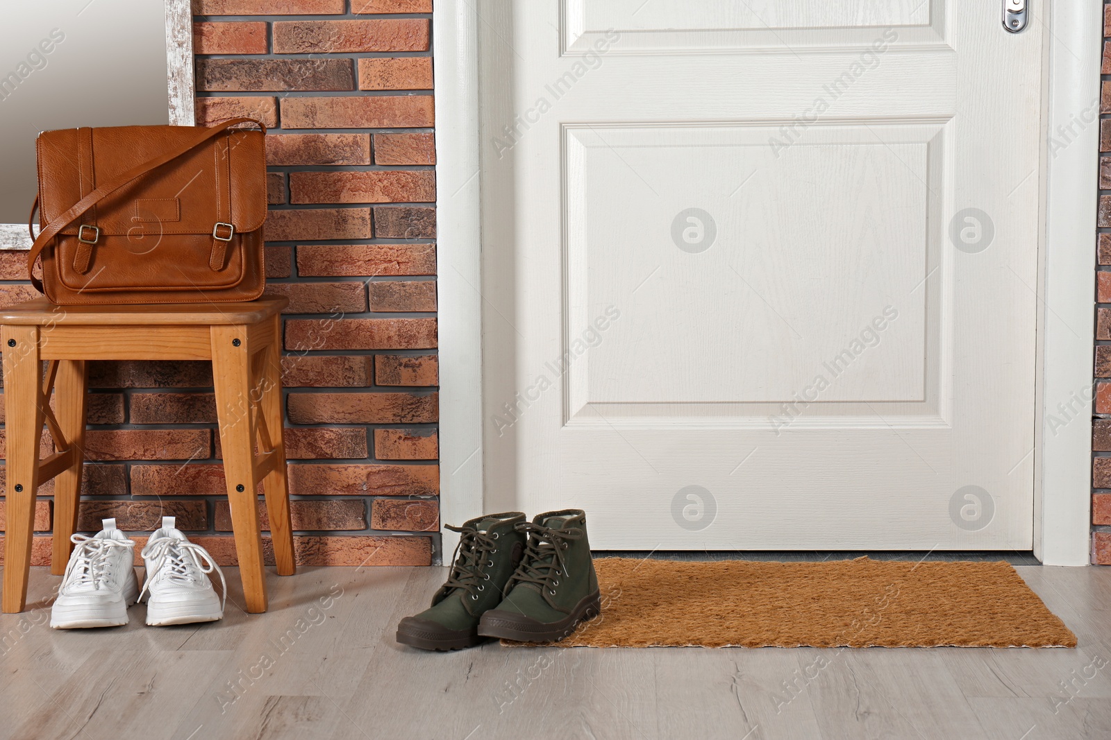 Photo of Hallway interior with shoes, bag and mat near door