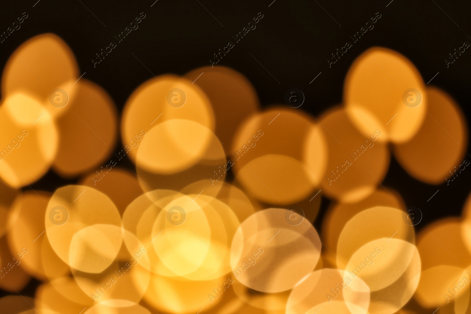 Photo of Beautiful golden lights on dark background. Bokeh effect