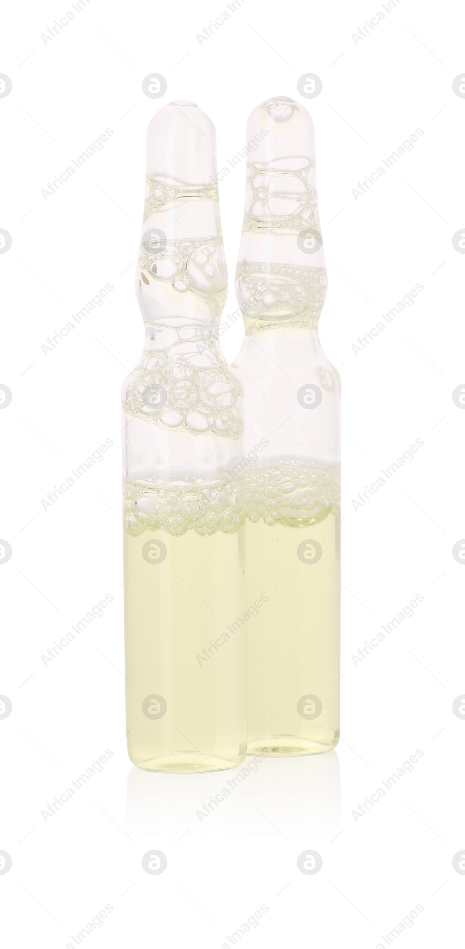 Photo of Glass ampoules with liquid isolated on white