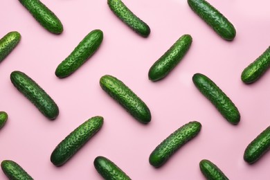 Photo of Flat lay composition with fresh ripe cucumbers on pink background