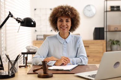 Photo of Notary with clipboard and pen at workplace in office