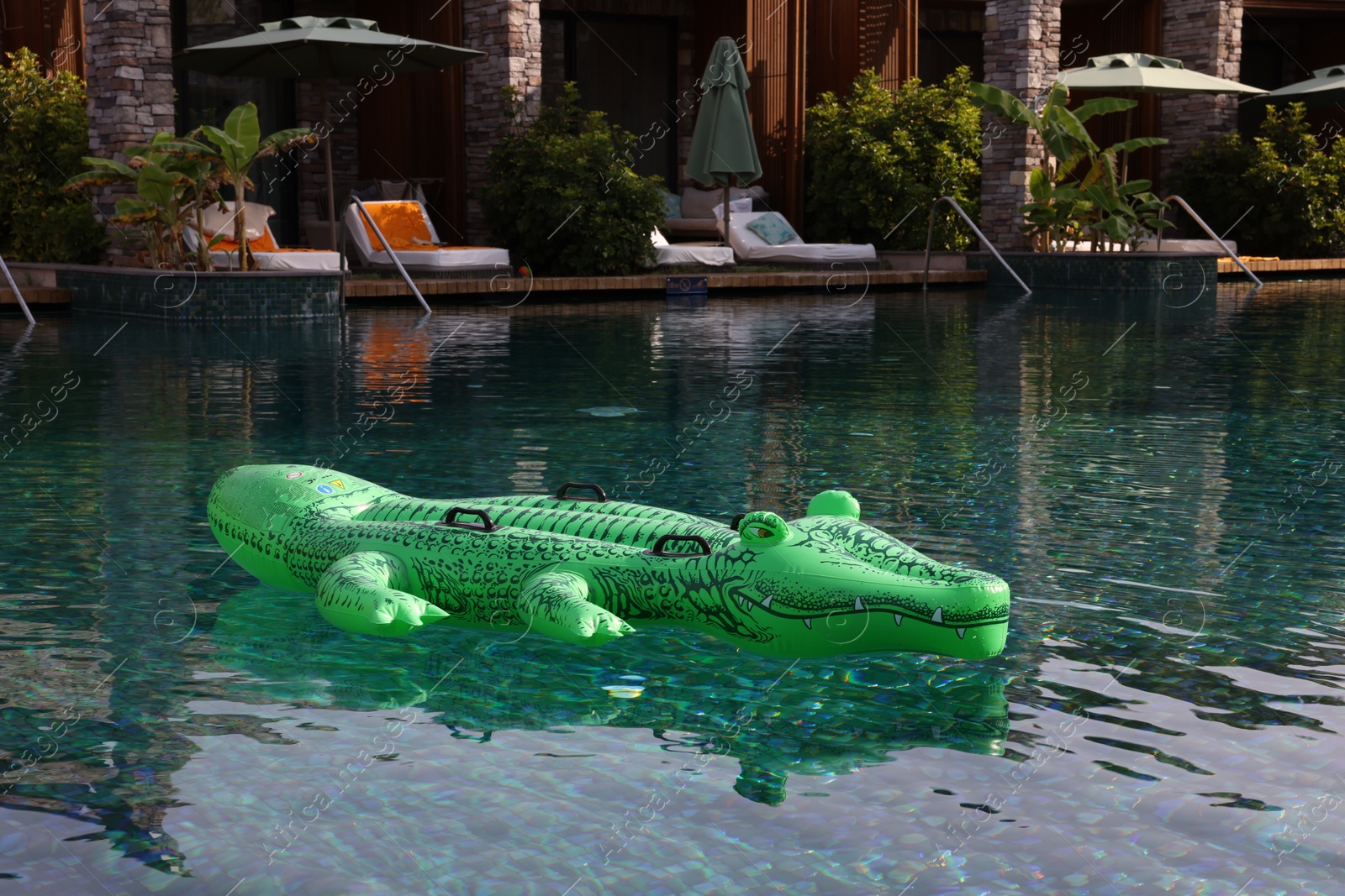 Photo of Float in shape of crocodile in swimming pool at luxury resort