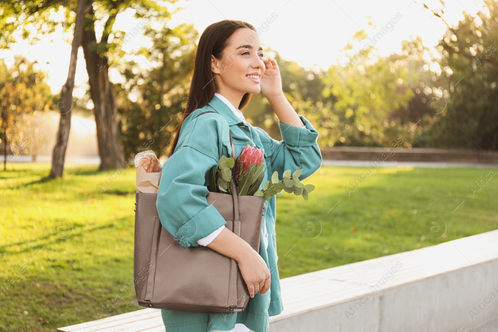 Photo of Woman with leather shopper bag in park, closeup