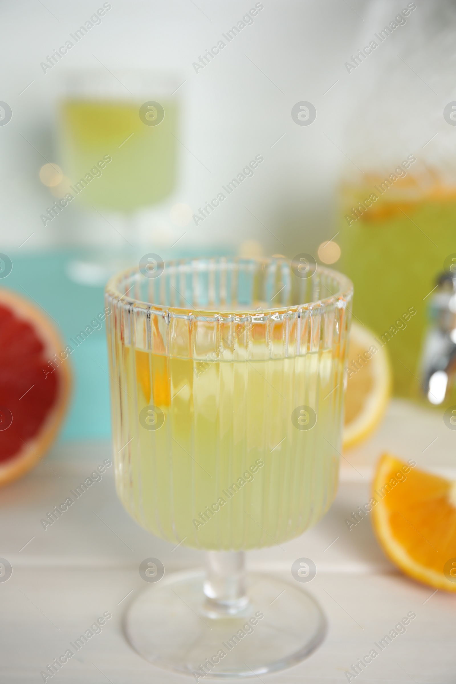 Photo of Delicious refreshing lemonade on white wooden table