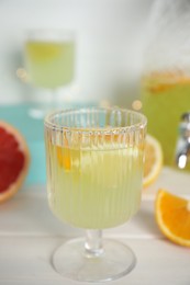 Delicious refreshing lemonade on white wooden table