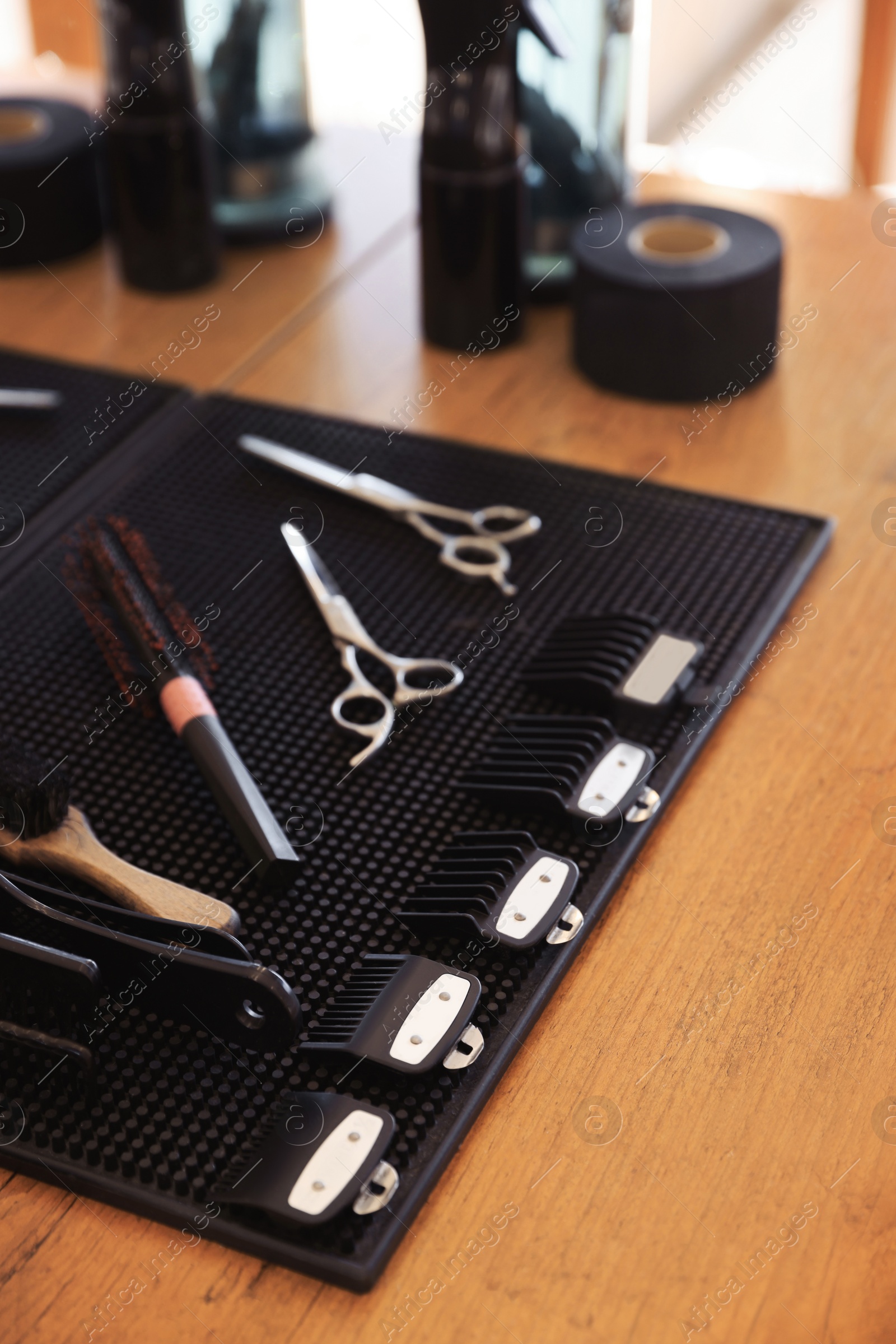Photo of Stylish hairdresser's workplace with professional tools and cosmetic products in barbershop