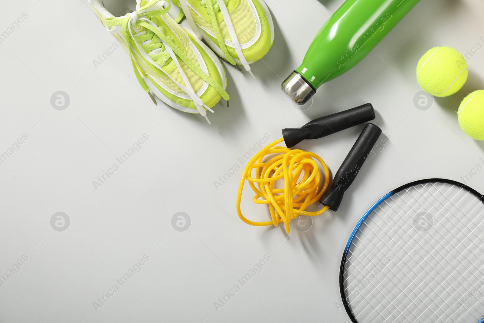 Photo of Different sports equipment on light grey background, flat lay. Space for text