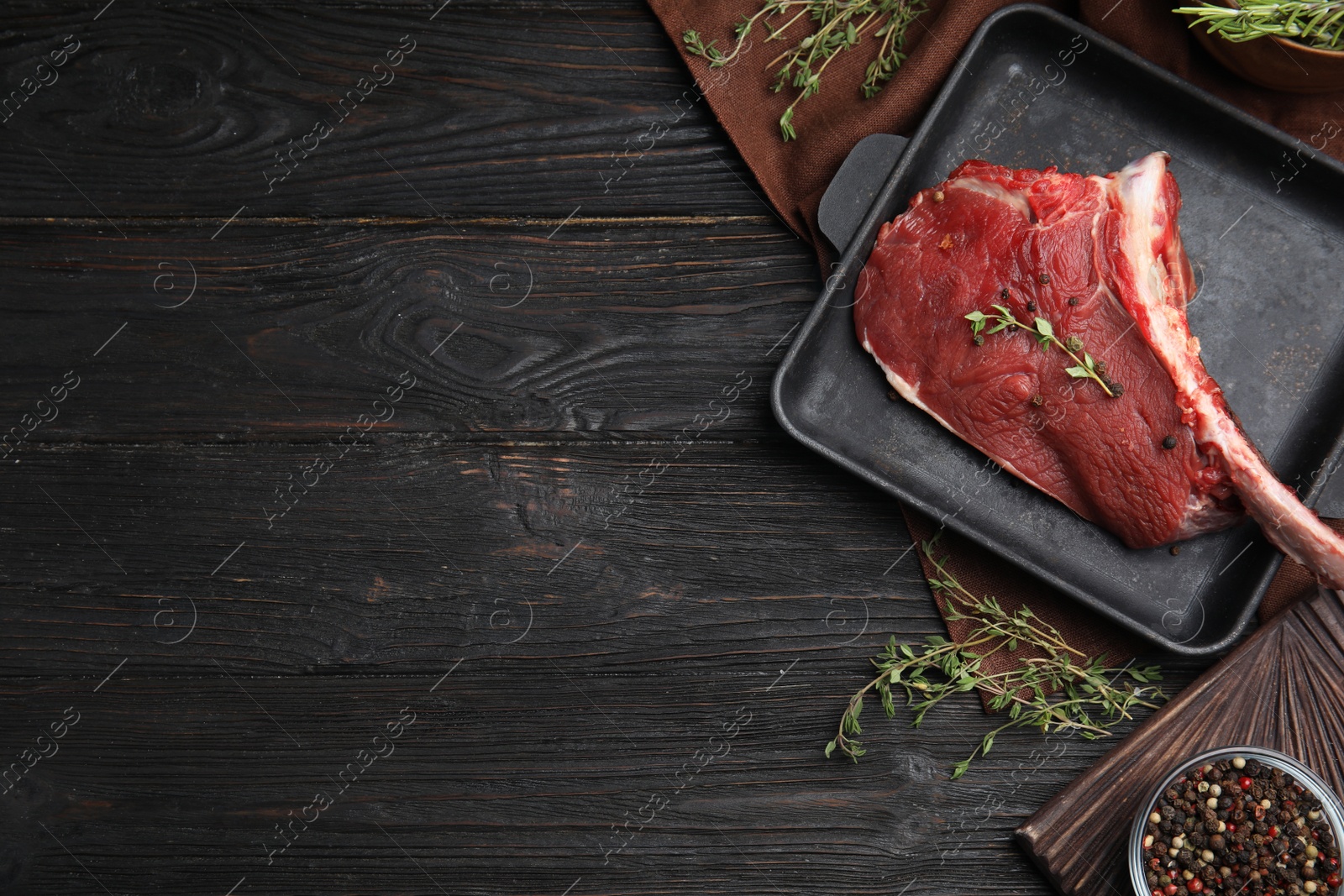 Photo of Flat lay composition with fresh beef cut on wooden table. Space for text