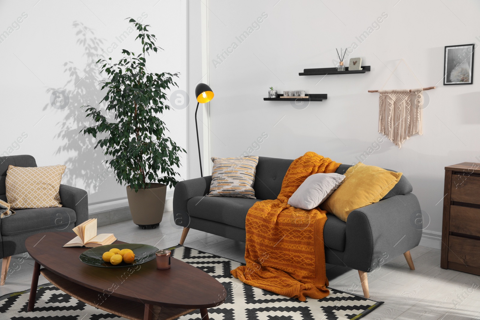 Photo of Stylish living room interior with comfortable sofa and wooden table