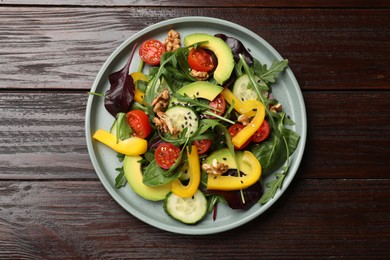 Photo of Balanced diet and vegetarian foods. Plate with different delicious products on wooden table, top view