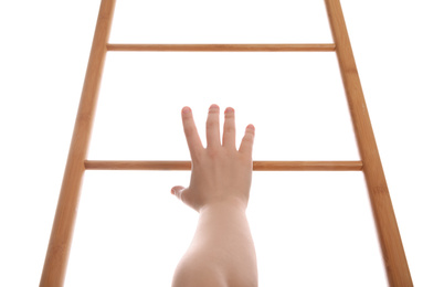Woman climbing up wooden ladder against white background, closeup