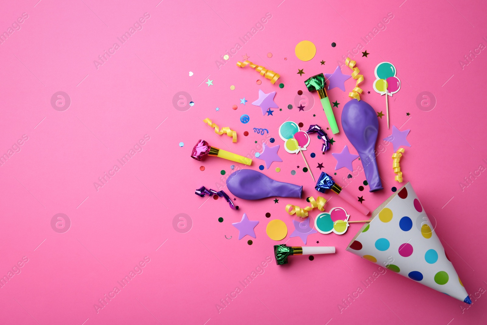 Photo of Flat lay composition with party cap on pink background. Space for text