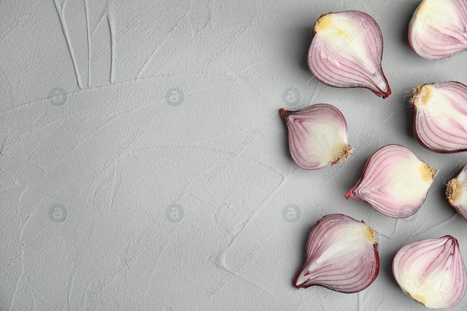 Photo of Ripe cut red onions on table, top view