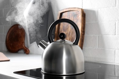Steaming kettle on electric stove in kitchen